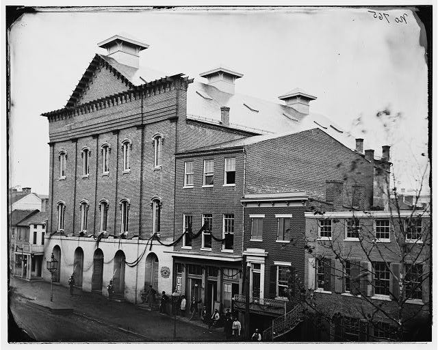 Ford's Theatre in April 1865, after Lincoln's assassination. Note the guards at the entrance and the crepe draped from the windows.